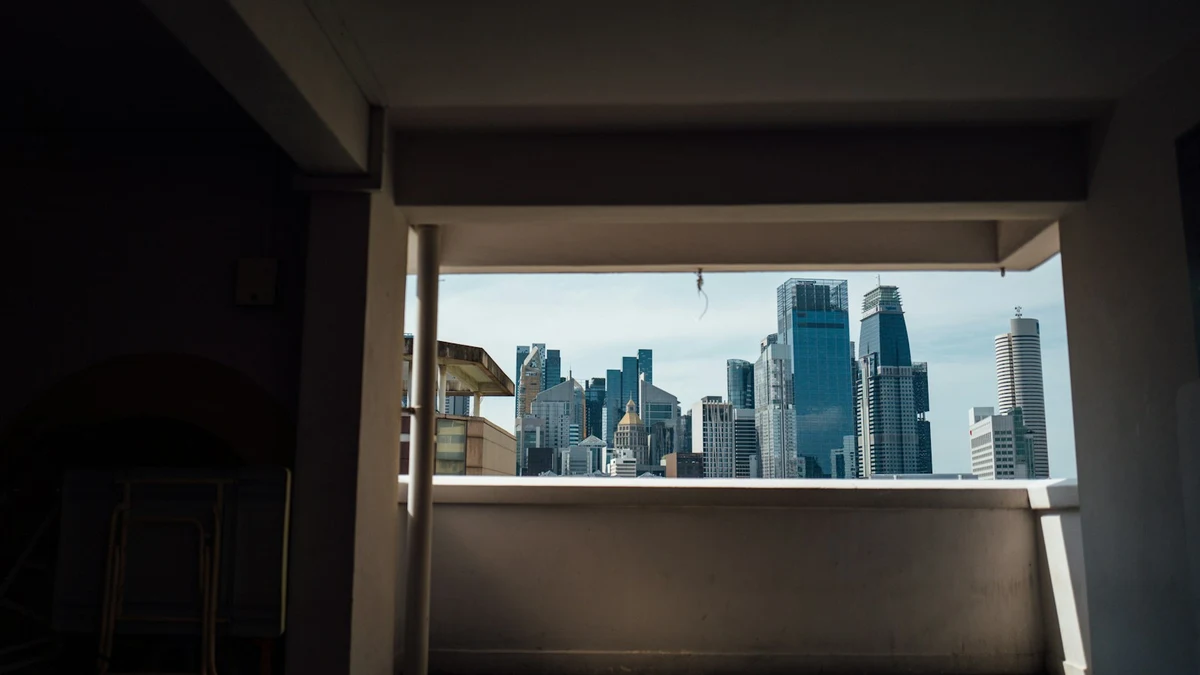 A business district skyline framed by a concrete opening