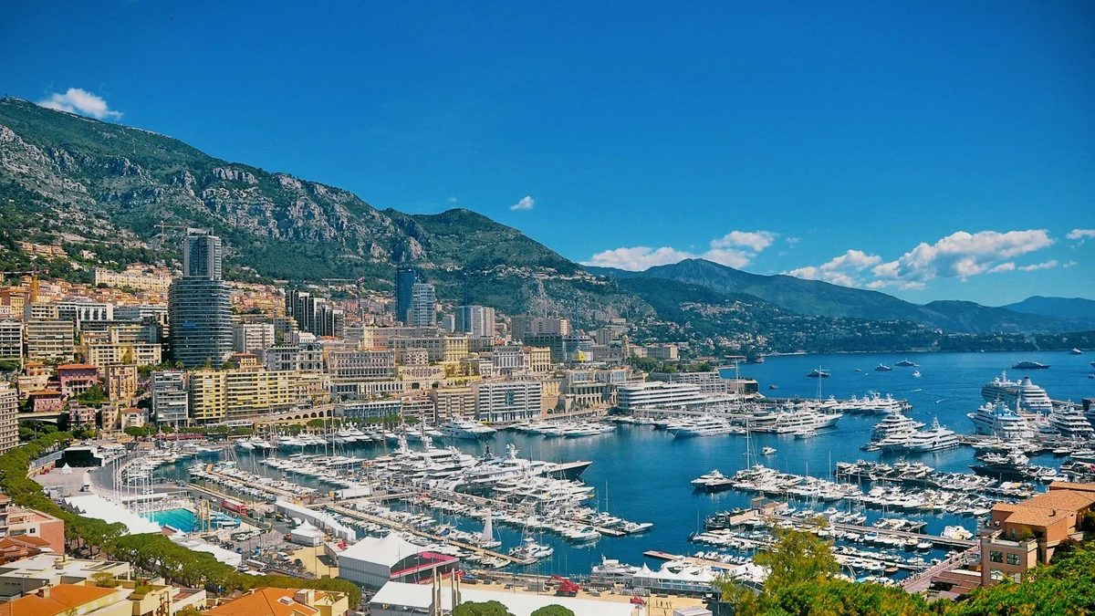 Monaco seen from the heights above, apartment blocks packed between steep mountains and a harbour full of yachts