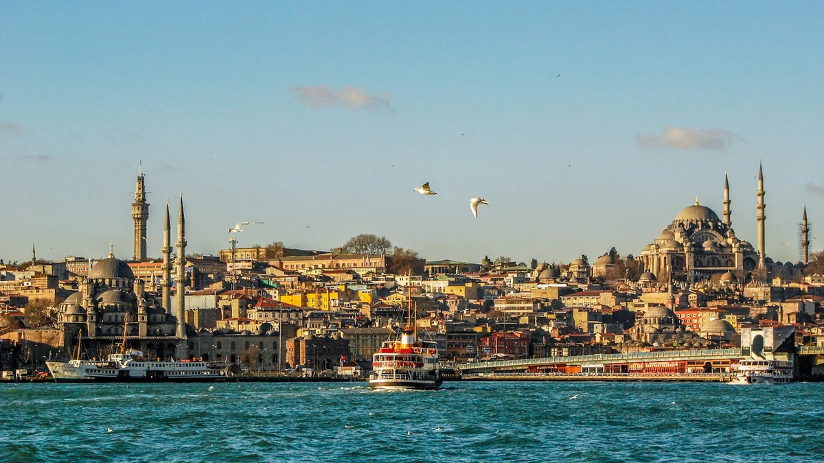 Istanbul waterfront at the Golden Horn with mosque domes, minarets and a passenger ferry