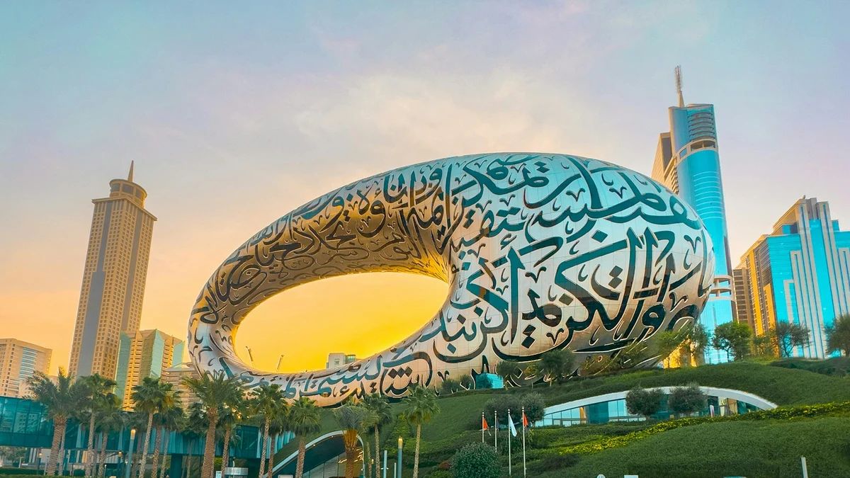 The Museum of the Future in Dubai, a steel ring covered in Arabic calligraphy, glowing at sunset between office towers