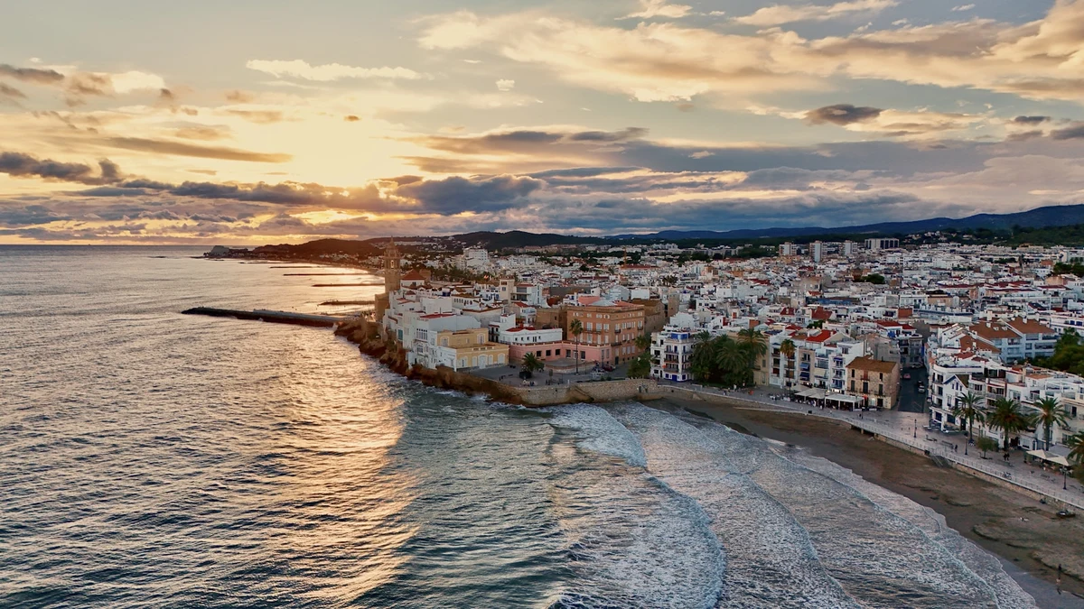 Mediterranean coastal town at sunset with the sea in the foreground