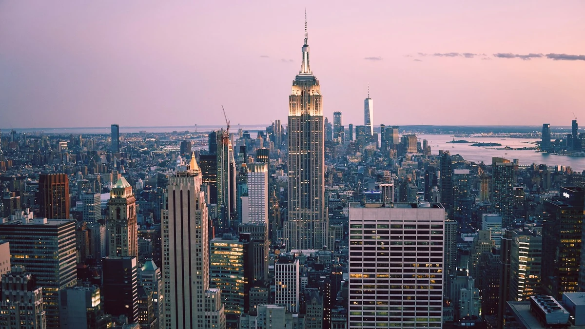 Midtown Manhattan at dusk, the Empire State Building lit against a pink sky